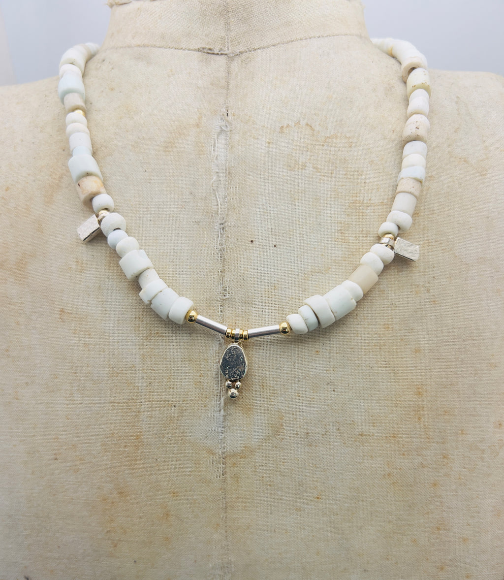 Porcelain trade beads with silver and gold.