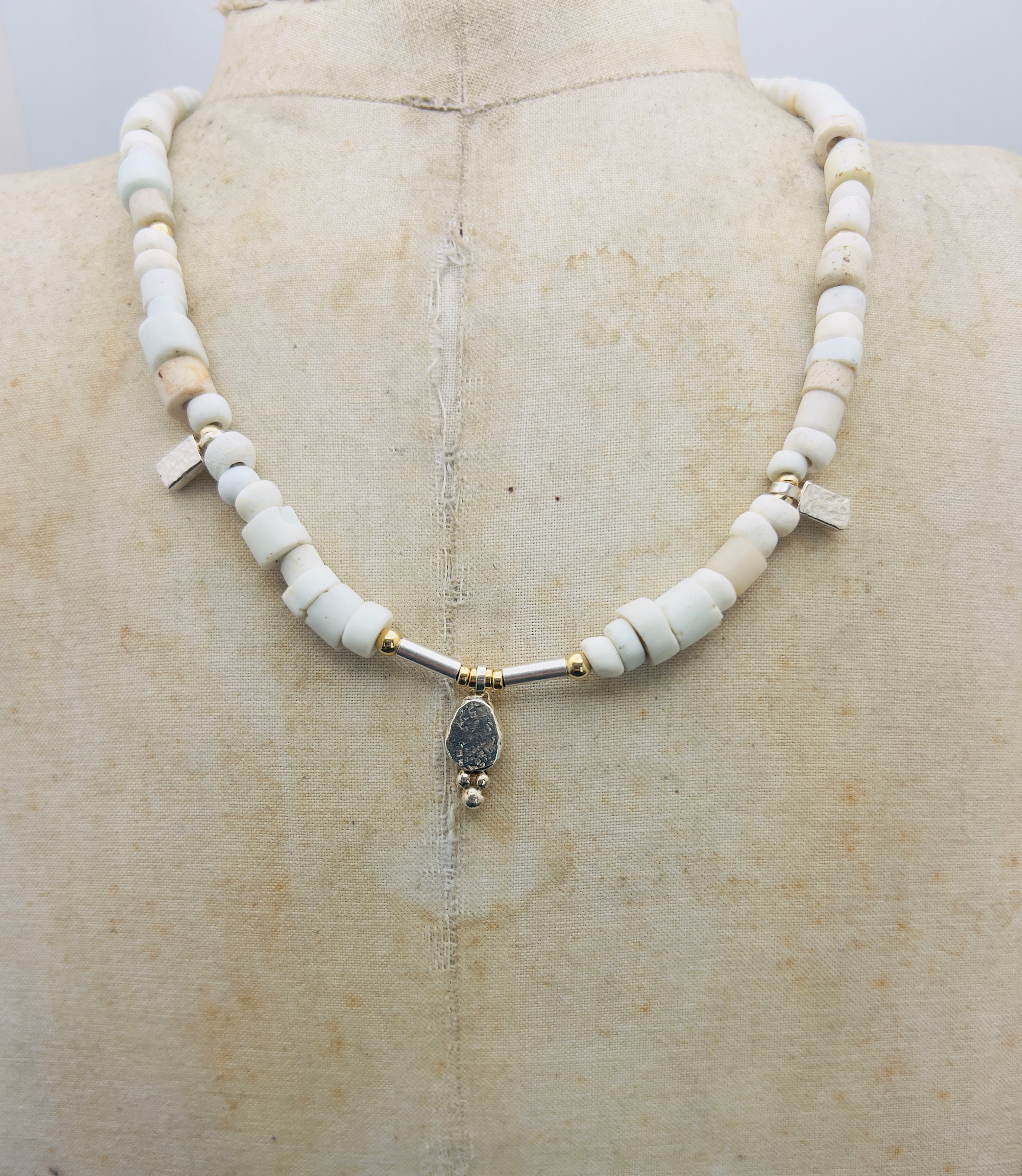 Porcelain trade beads with silver and gold.
