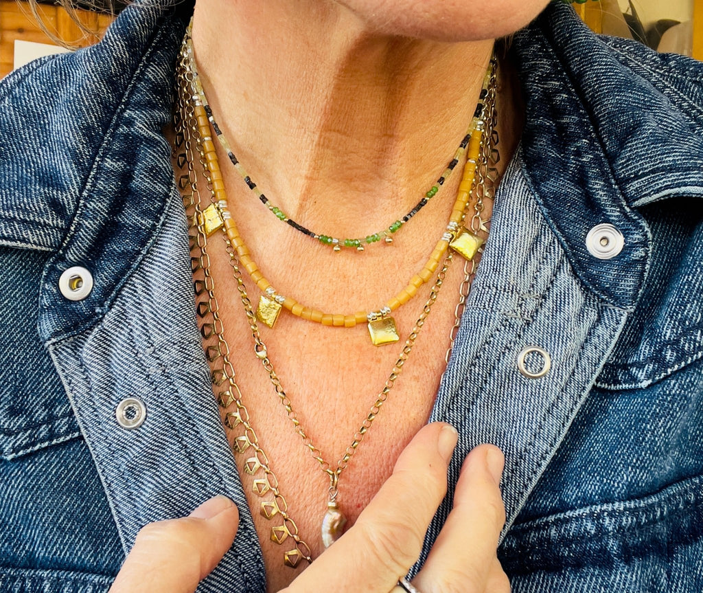Tan tiles and gold necklace