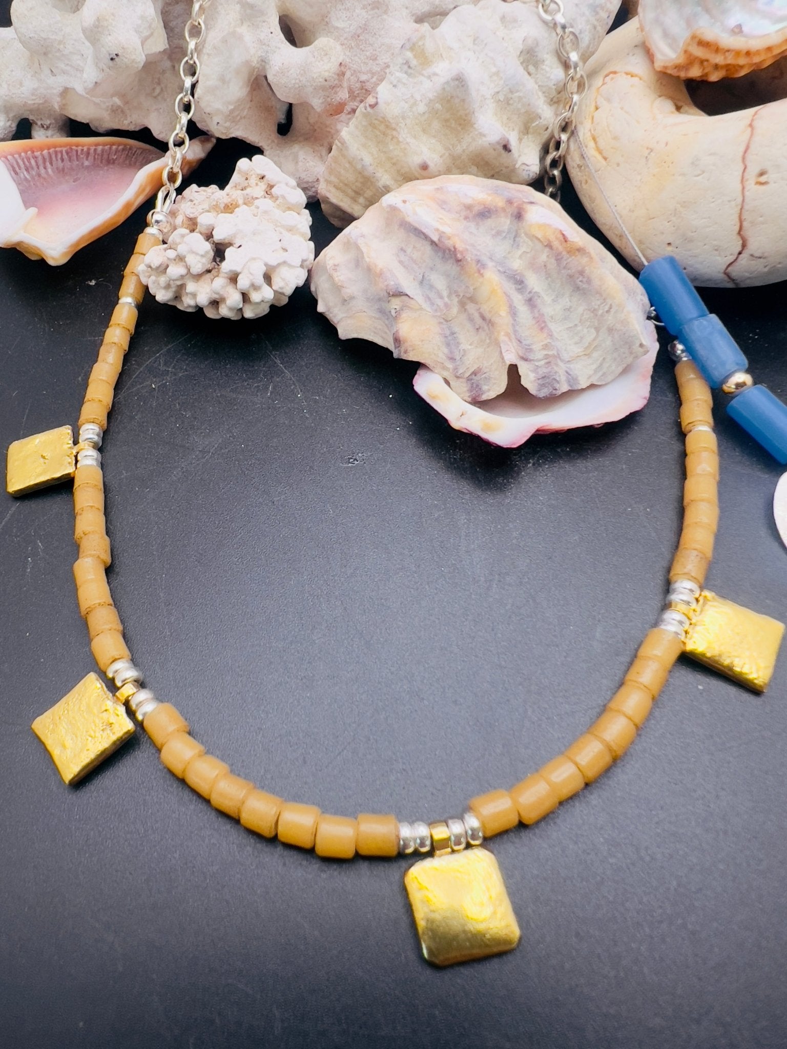 Tan tiles and gold necklace