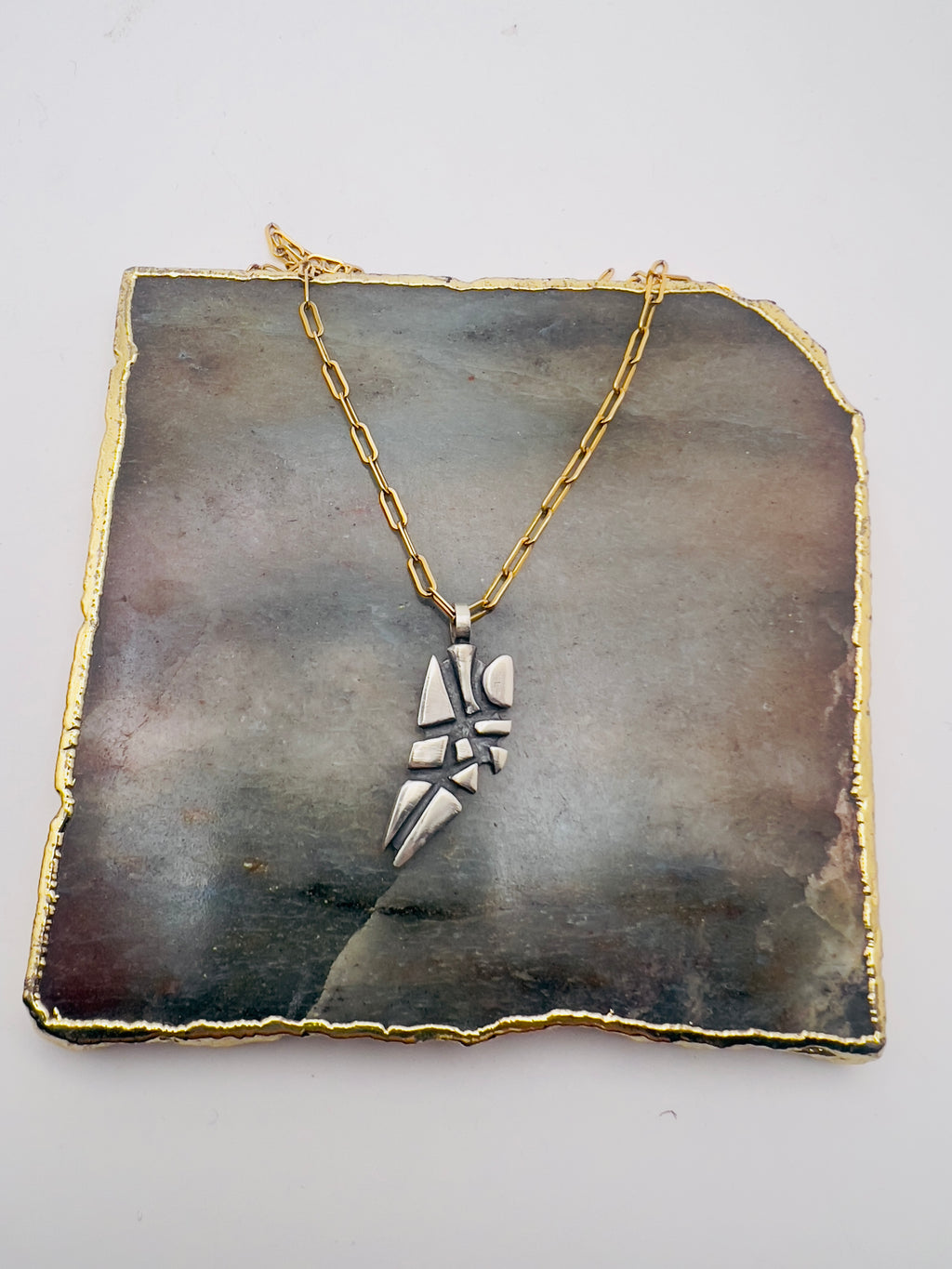 Parched earth pendant on gold chain