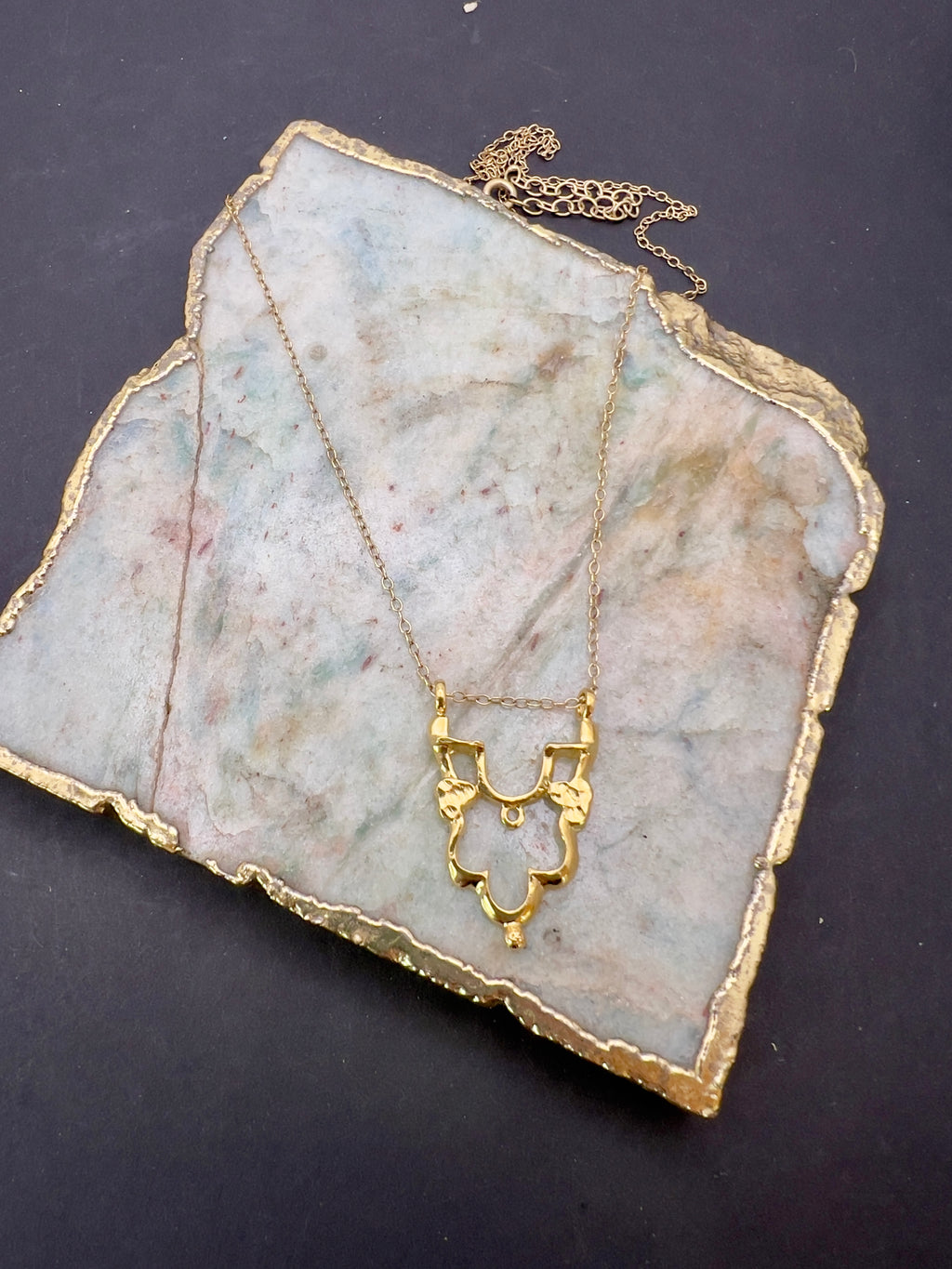 Gold Shikara half pendant.