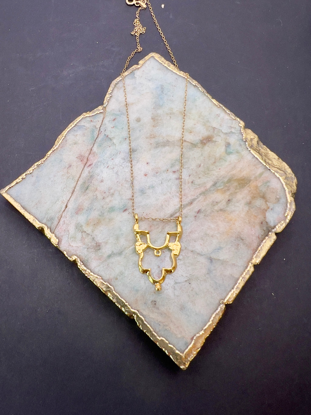Gold Shikara half pendant.