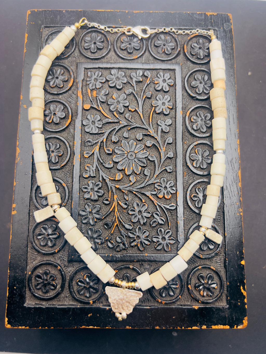 Porcelain trade beads with silver and gold.