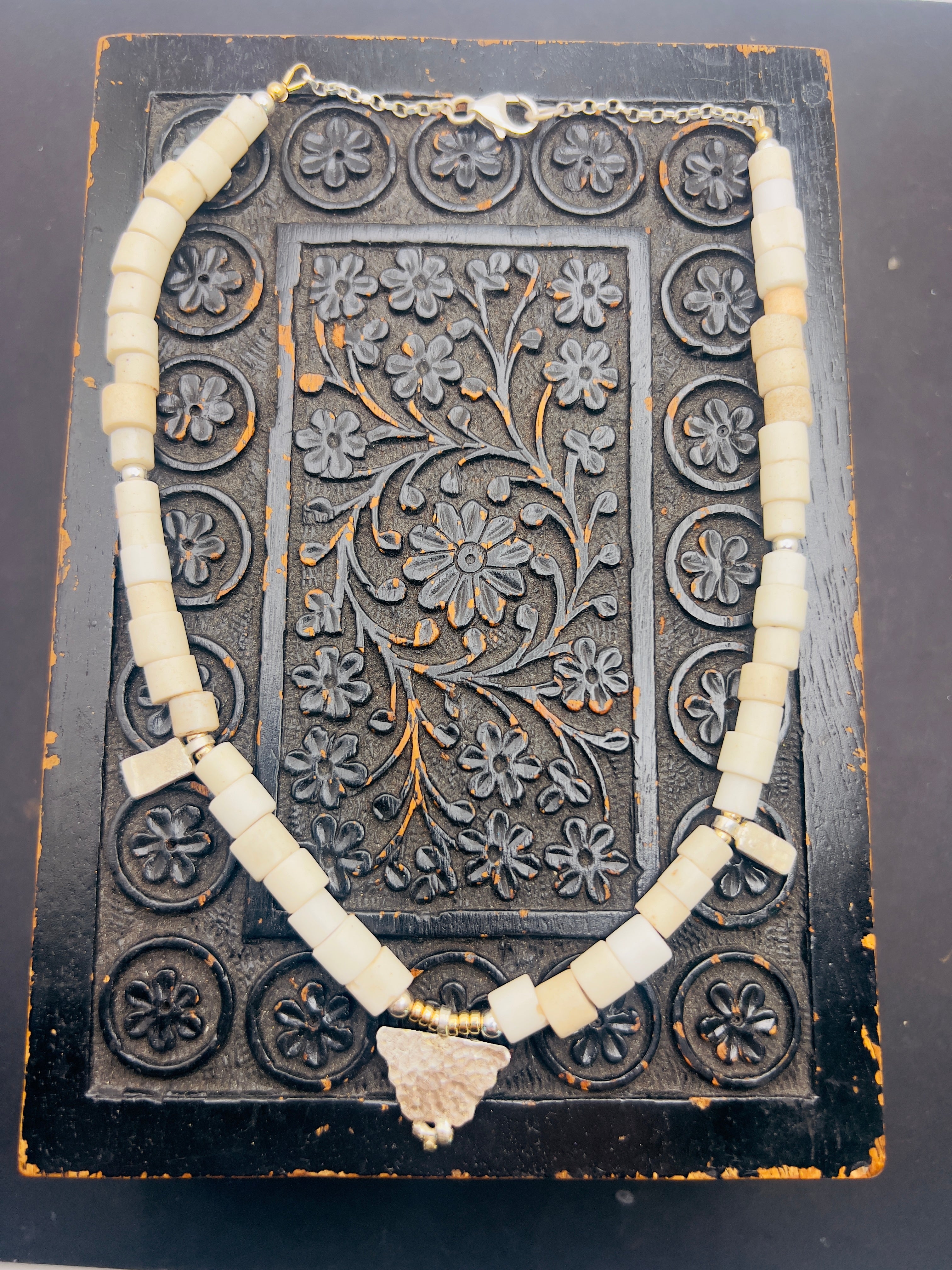 Porcelain trade beads with silver and gold.