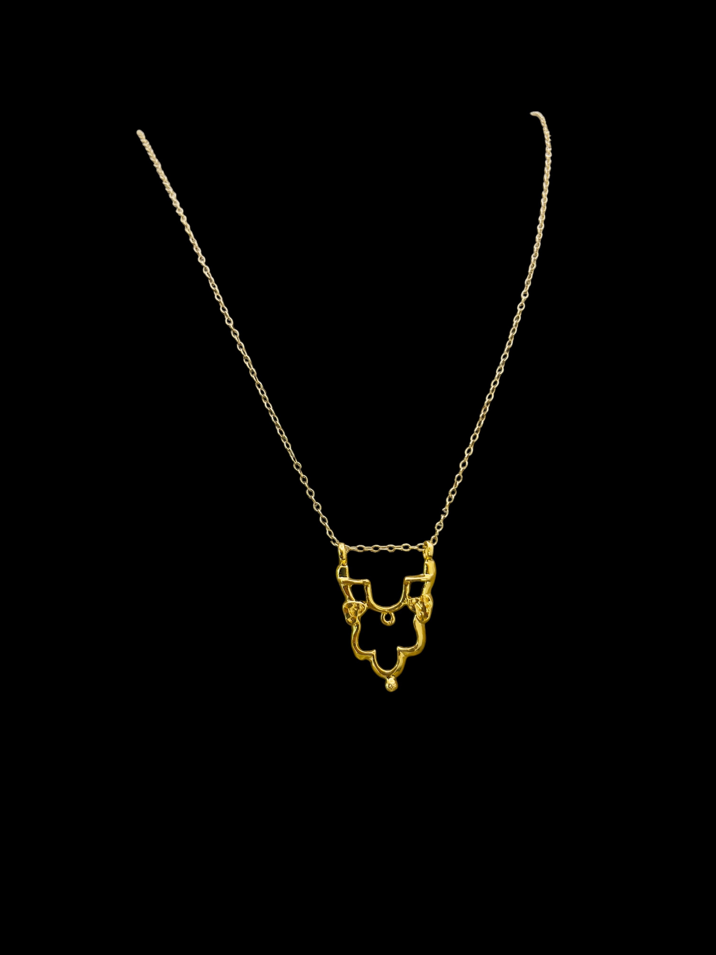 Gold Shikara half pendant.