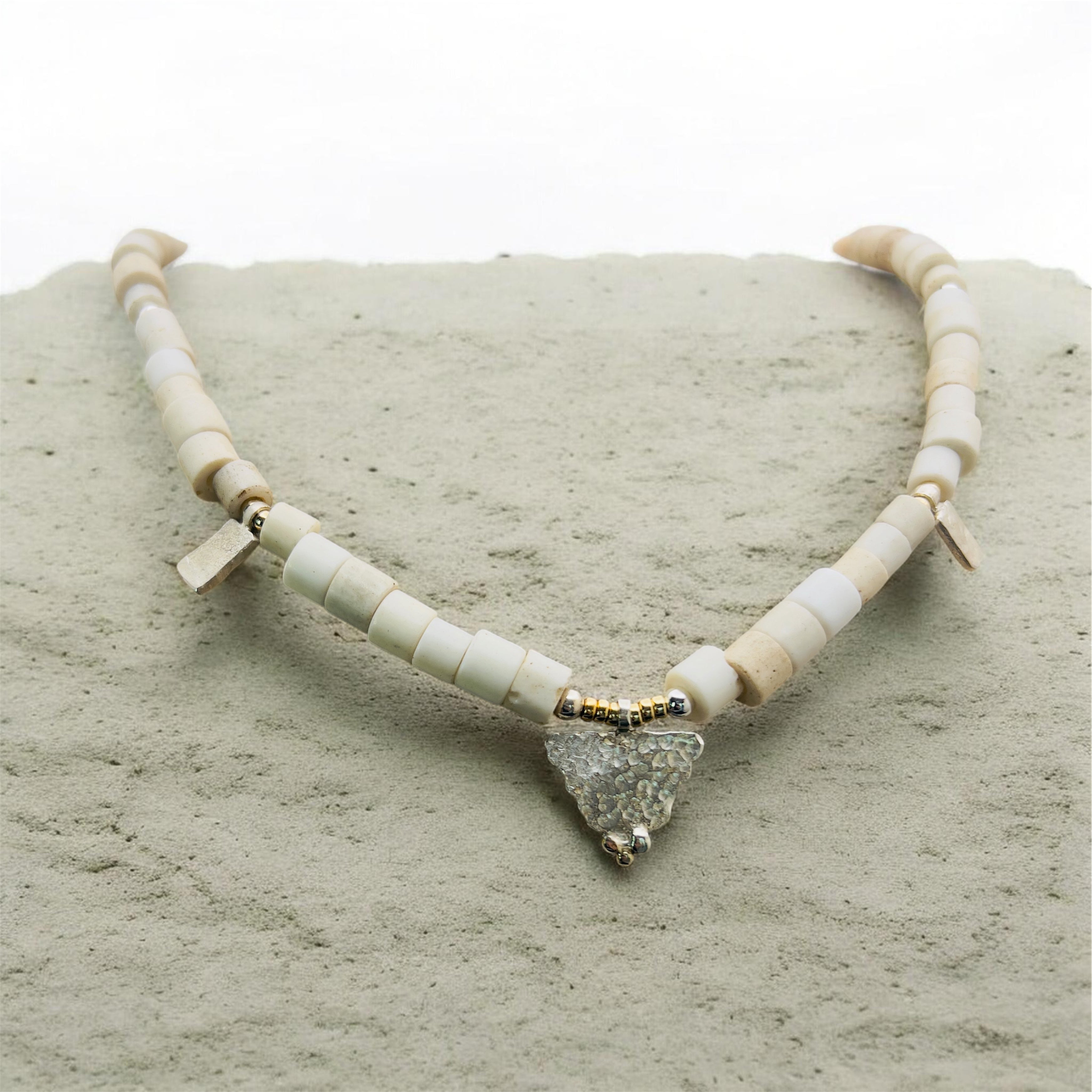 Porcelain trade beads with silver and gold.