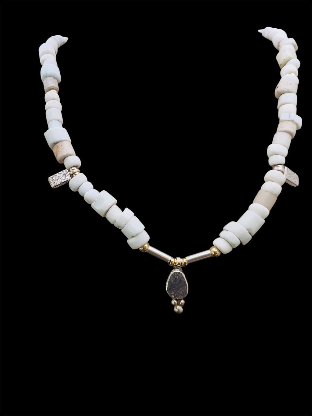 Porcelain trade beads with silver and gold.