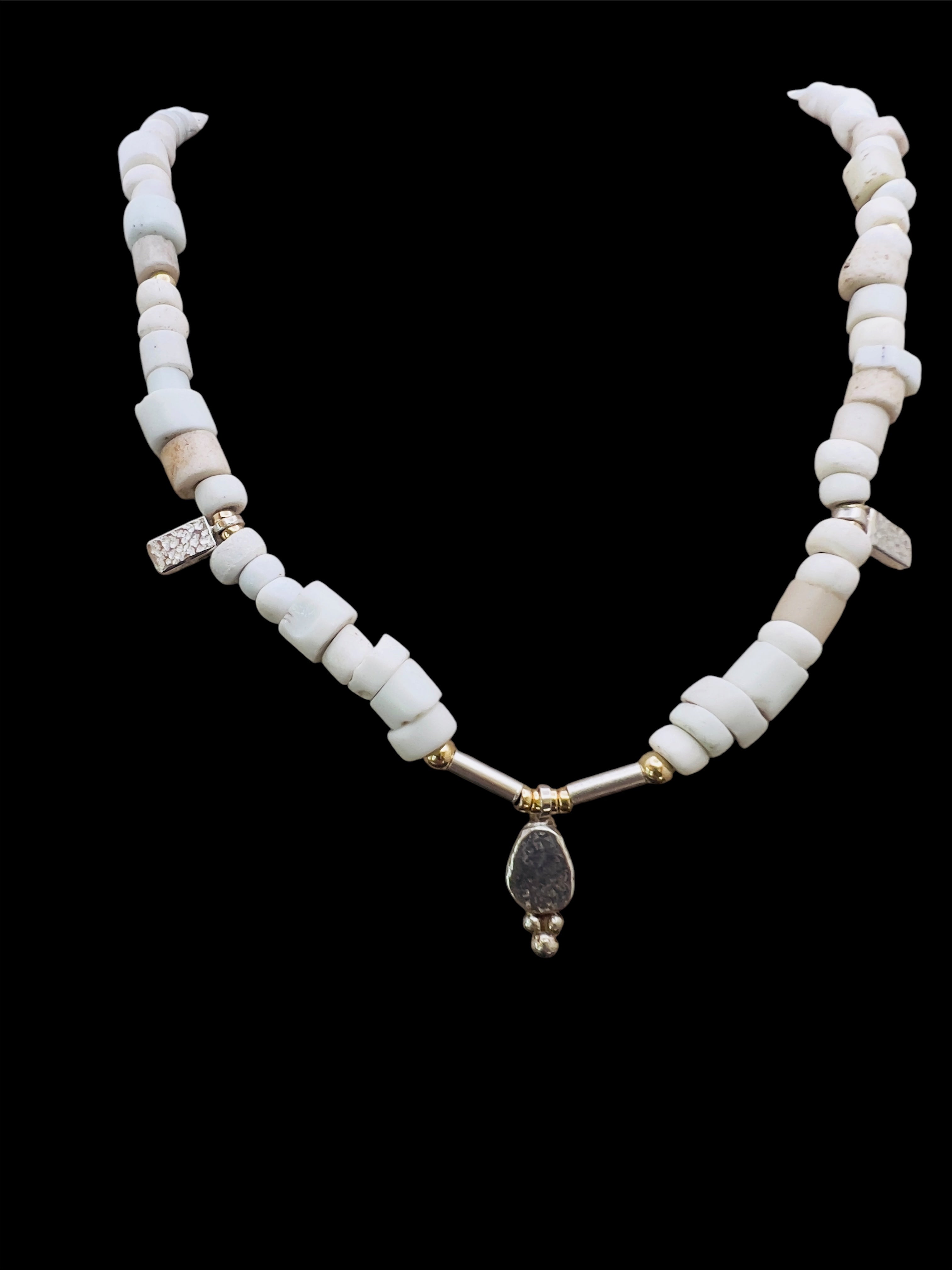 Porcelain trade beads with silver and gold.